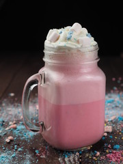 Tasty cocktail and sweets on a wooden table