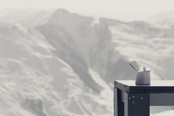Old table with sugar bowl in outdoor cafe at ski resort
