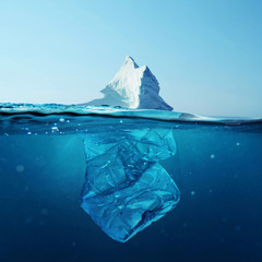 Iceberg with bottle in the ocean underwater. Environmental pollution. Plastic water bottles pollute...