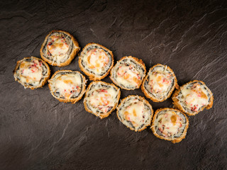 Portion of hot rolls with cheese and caviar in Japanese style, top view