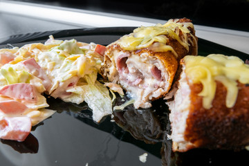 Ketogenic dish, pork meat stuffed with processed cheese and ham