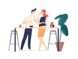 Smiling man and woman standing in kitchen, eating snacks and feeding each other. Happy boy and girl having breakfast lunch. Cute couple enjoying food together. Flat cartoon vector illustration.
