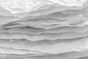 Closeup of white crumpled paper layers stack. Abstract art background. Copy space.
