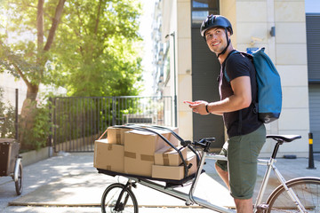 Bicycle messenger making a delivery on a cargo bike