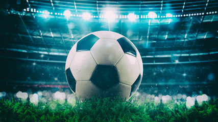 Close up of a soccer ball in the center of the stadium illuminated by the headlights