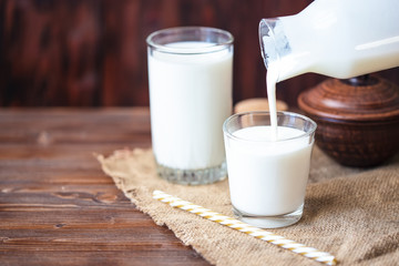 Pouring homemade kefir, yogurt with probiotics Probiotic cold fermented dairy drink Trendy food and...