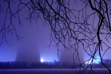 Power station at night in fog