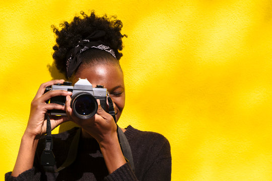 African woman with camera in her hands close up