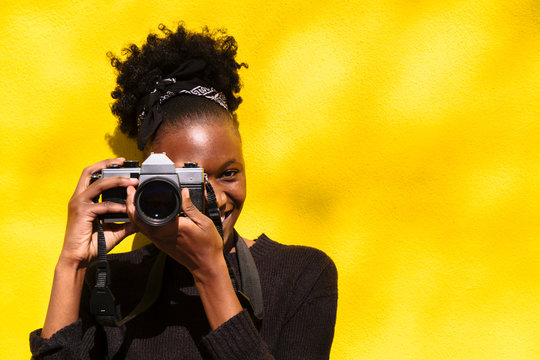 African woman with camera in her hands close up