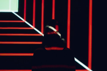 Beautiful woman posing in front of projector.