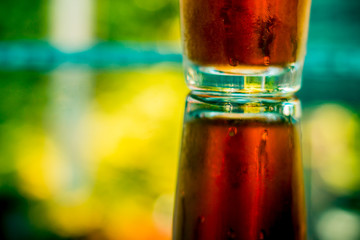 Glass of cold natural ice tea at the bar – Fruity and refreshing beverage on a hot summer day...