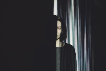 Beautiful woman posing in front of projector.