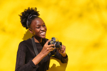 Happy african girl with digital camera outdoor