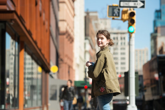 Woman walking with notebook in city