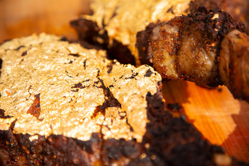 A medium rare tomahawk steak covered with a layer of gold