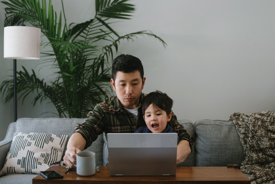 Dad and son on laptop