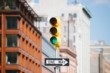 Traffic light in front of city buildings