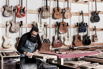 Guitar luthier working in his workshop