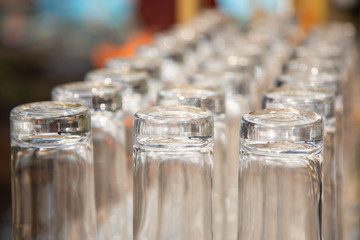 Several clean cocktail glasses are ready for use at a bar