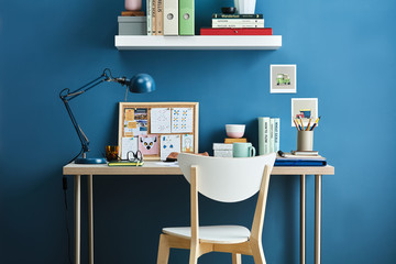 White wooden chair at student's desk with different things.