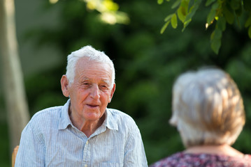 Old man and woman talking in park