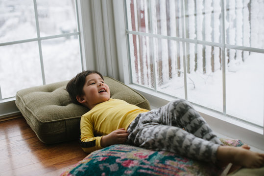 Little kid in pajamas on lazy snow day