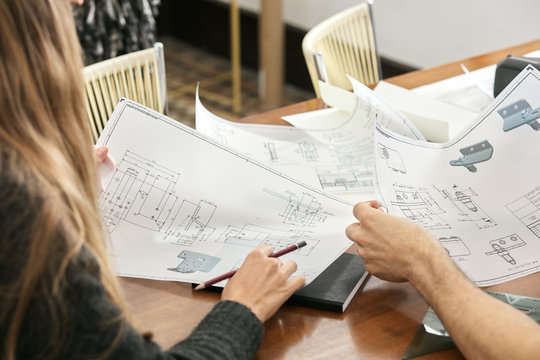 Workers with drawings in the office.