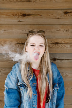 Young woman smoking and enjoy free time at park.