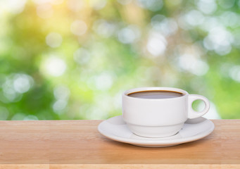Empty wood table top and coffee cup blur nature background with copy space for display or montage your products