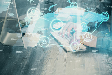 Social network theme hologram with businessman working on computer on background. Concept of world wide web. Multi exposure.