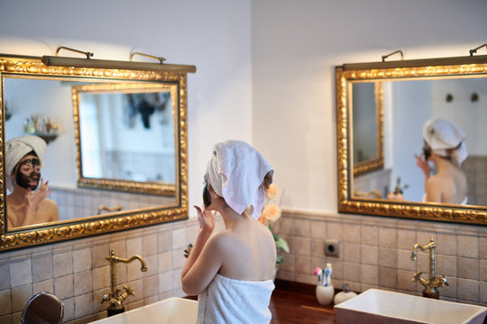 Girl taking beauty care in bathroom