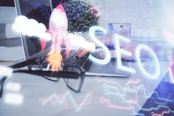 Multi exposure of seo icon with man working on computer on background. Concept of search engine...