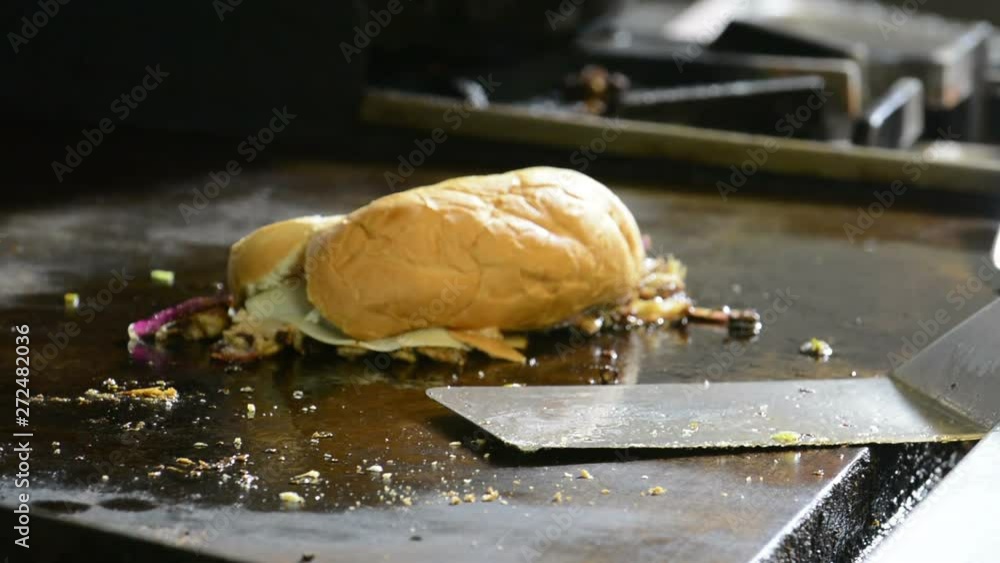 Sticker Chef cooking a Philly steak sandwich on a grill