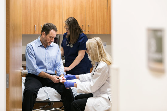 Clinic: Man With Bad Cut On Hand Sees Doctor