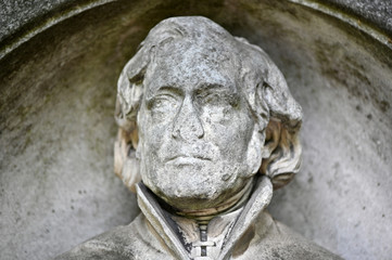 Obraz premium A damaged face of an old sandstone sculpture.