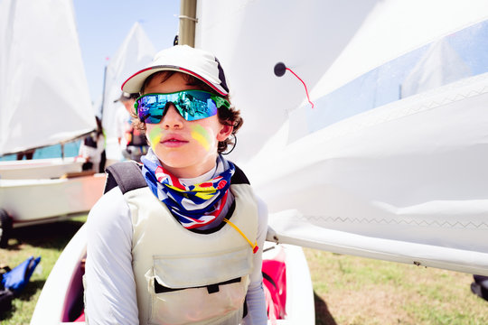 Boy in sailing gear waiting to launch at a sailing regatta