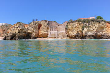 Fototapeta na wymiar Panoramic landscape view of golden cliffs and emerald water in Ponta da Piedade, Lagos, Algarve, Portugal