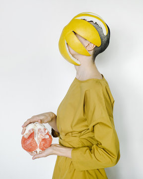 Bald woman with pomelo and peel