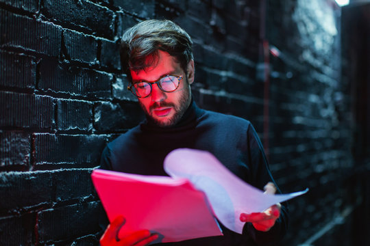Actor reviewing script in theatre.