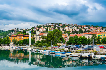 Fototapeta na wymiar Rijeka, Croatia: Rjecina river with Liberation Monument, boats and view over the city and Trsat castle