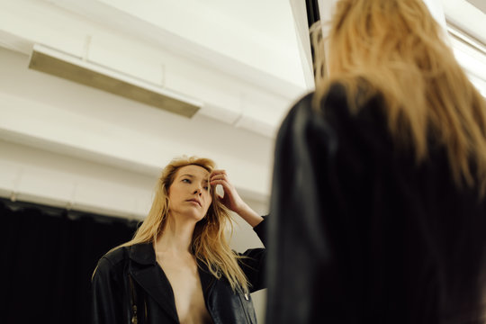 young woman looking at  the mirror