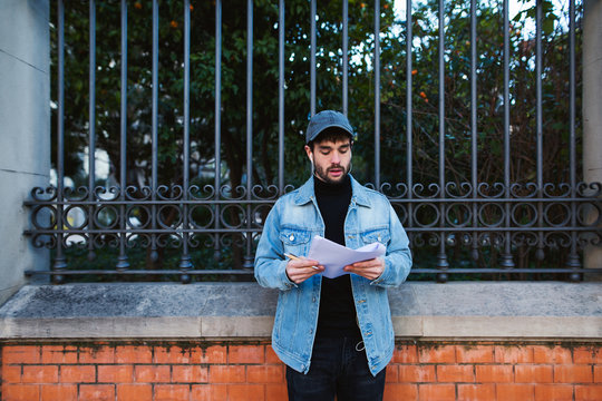 Actor reading script on the street.