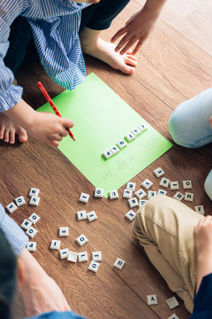 Teacher and preschool kids learning  in classroom