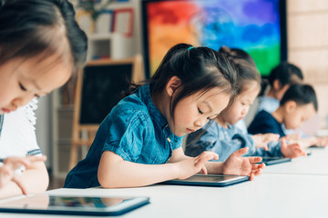 Students using digital tablets in classroom