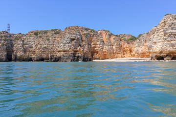 Fototapeta premium Panoramic landscape view of golden cliffs and emerald water in Ponta da Piedade, Lagos, Algarve, Portugal