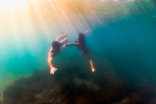 Man and woman do romantic intimate underwater dance