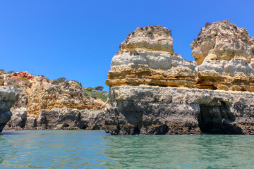 Fototapeta na wymiar Panoramic landscape view of golden cliffs and emerald water in Ponta da Piedade, Lagos, Algarve, Portugal