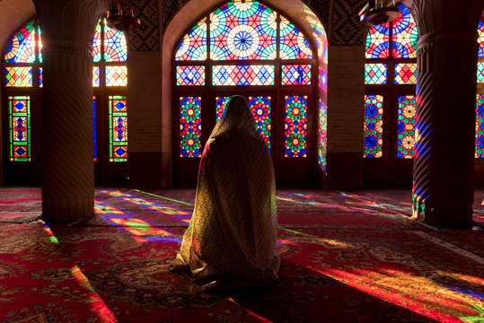 Anonymous woman inside of colorful oriental mosque
