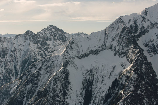 Snow covered mountain range with sunlit peaks