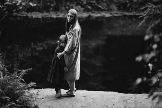 Little Girl And Mother At The River